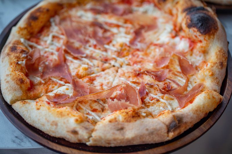Prosciutto and arugula artisan punch pizza with fresh toppings